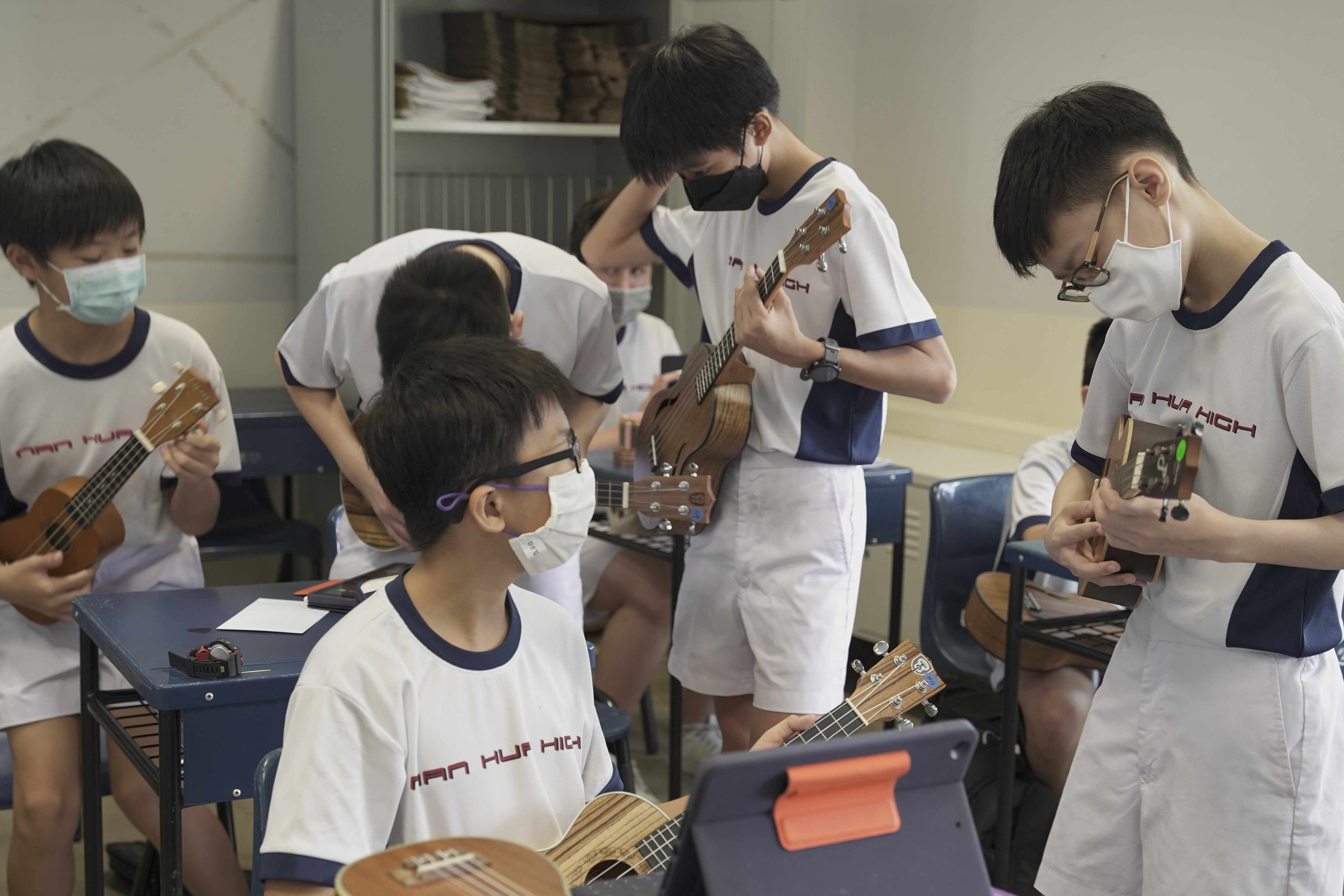 Secondary 1 students playing the ukelele during AAA Music module  